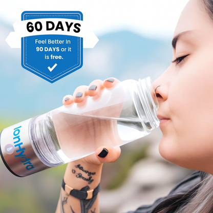 Woman drinking from IonHydra™ hydrogen water bottle outdoors with "60 Days Feel Better in 90 Days or It Is Free" badge visible